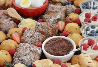 Delicious brunch charcuterie board featuring meats, cheeses, and fresh fruits.