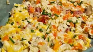 Delicious loaded scrambled eggs topped with cheese and vegetables